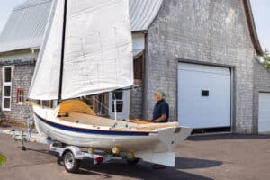 Kevin in front of his shop, alongside a NorseBoat 17.5 Classic - his flagship sailboat.
